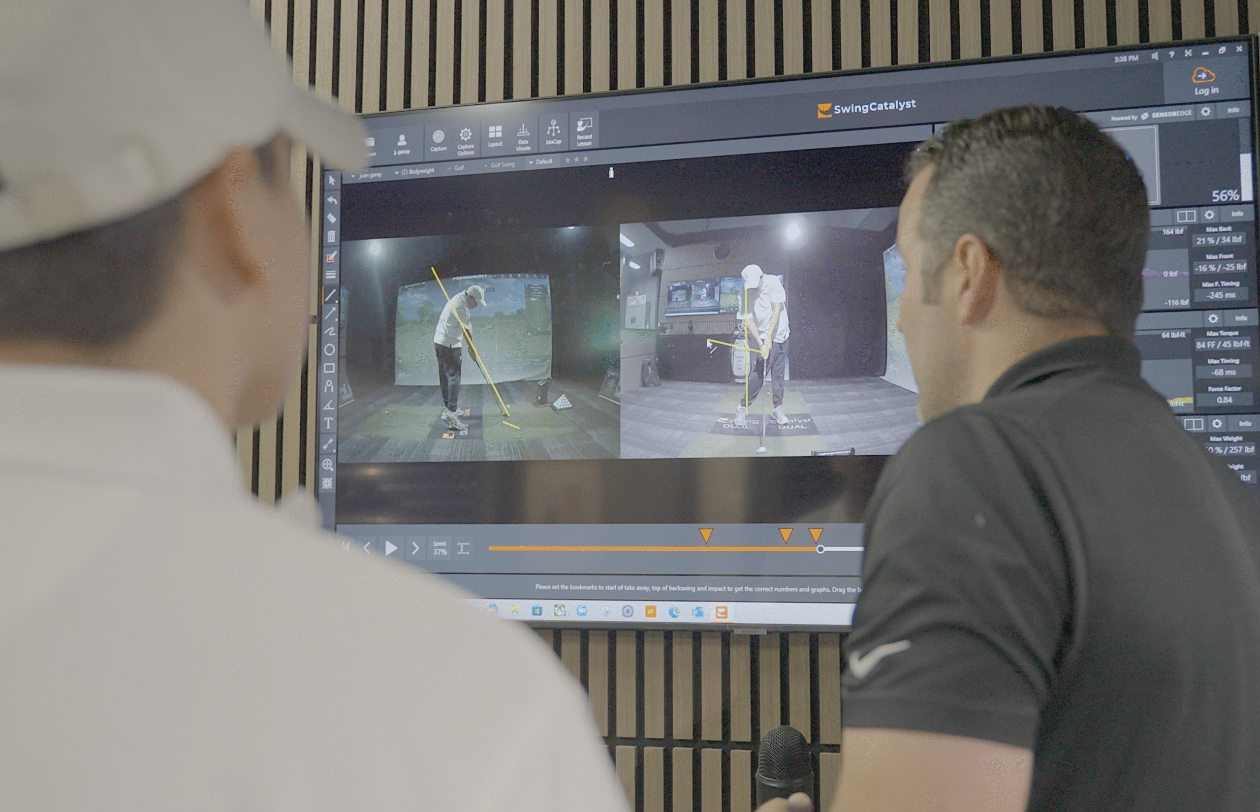 unior golfer reviewing high frame-rate swing video on a TV during a Swing Catalyst swing analysis lesson at Lago Golf
