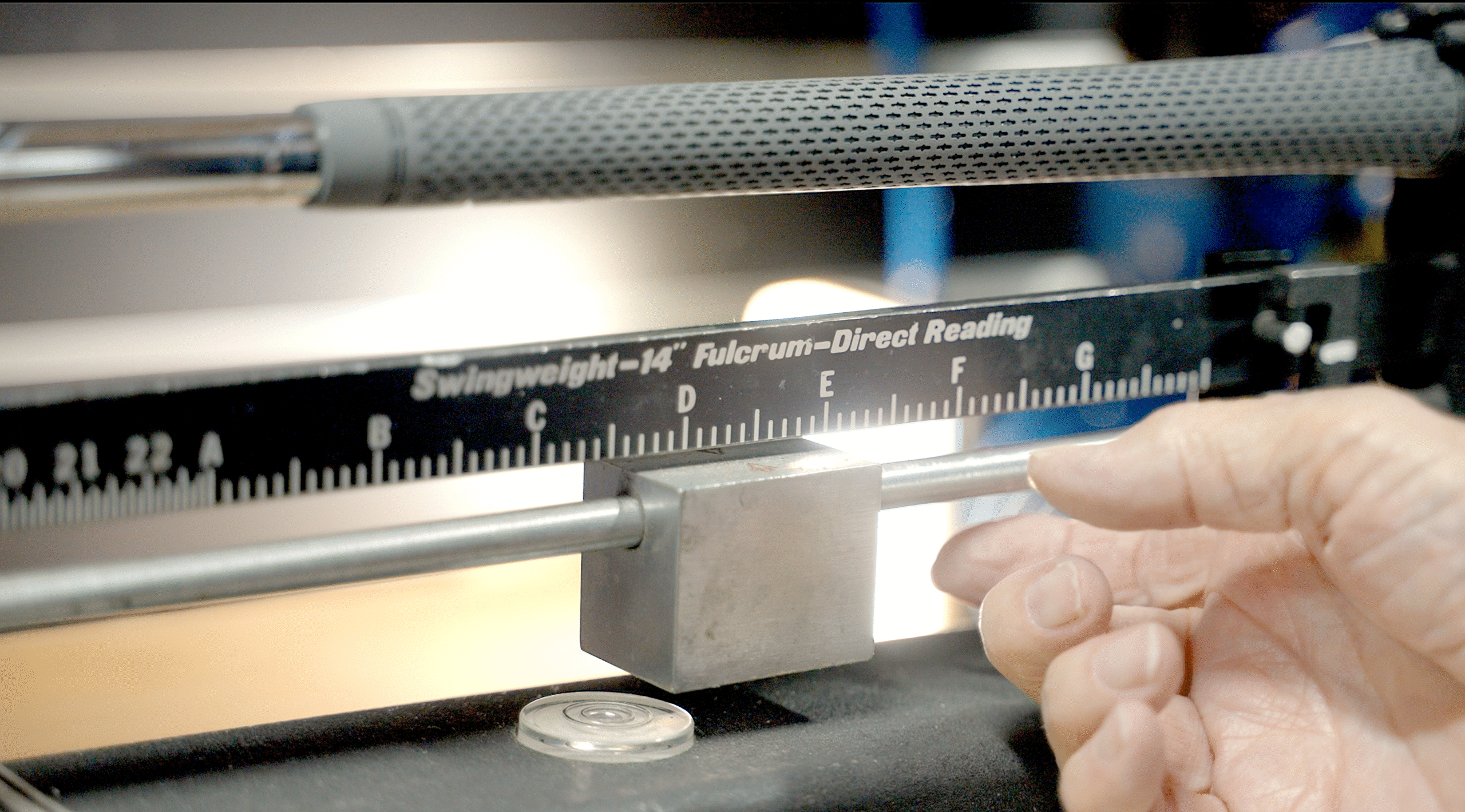 Swing weight machine measuring and swing-weighting a golf club at Lago Golf in Port Coquitlam, BC