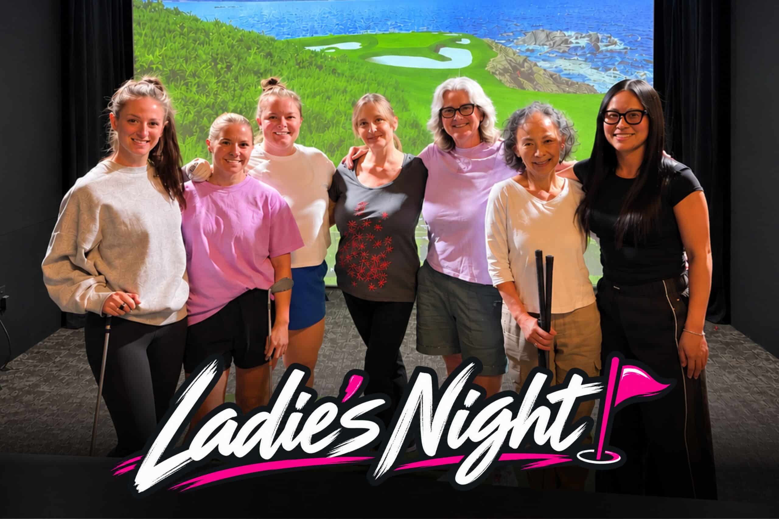 Women smiling together at Lago Golf's Ladies Night event on a golf simulator in Port Coquitlam