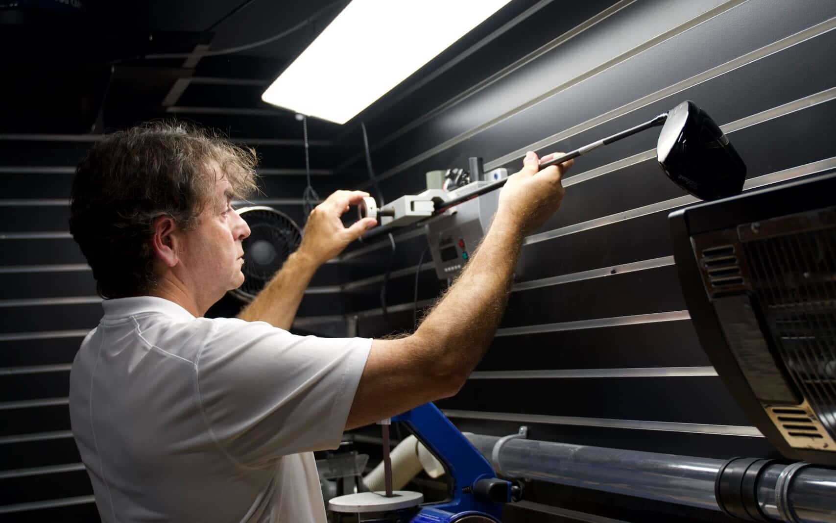 Lago Golf staff member using the shaft frequency machine during a club fitting in Port Coquitlam